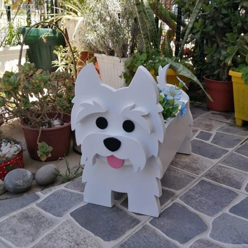 White dog-shaped planter with black eyes and a pink tongue, surrounded by potted plants on a stone patio.