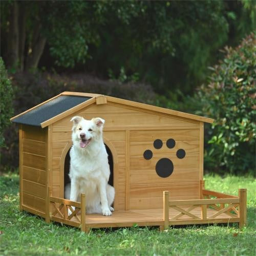 Dog sitting in a wooden doghouse with a paw print on a grassy area.