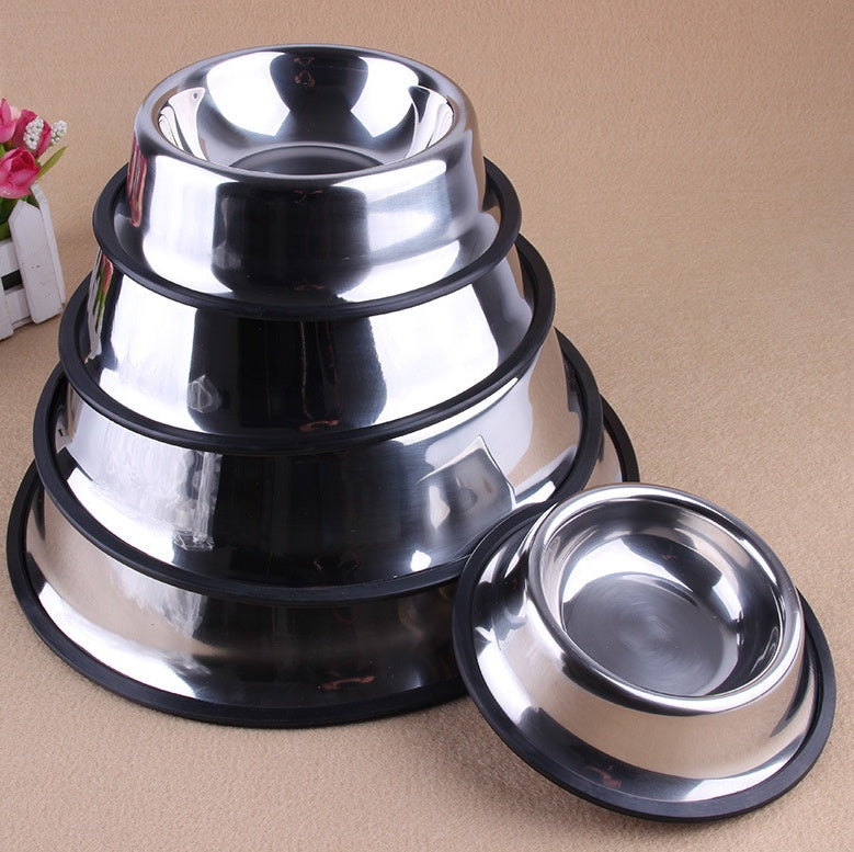 Set of stainless steel bowls stacked on a beige surface