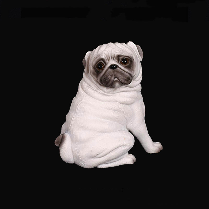 White pug figurine on a black background
