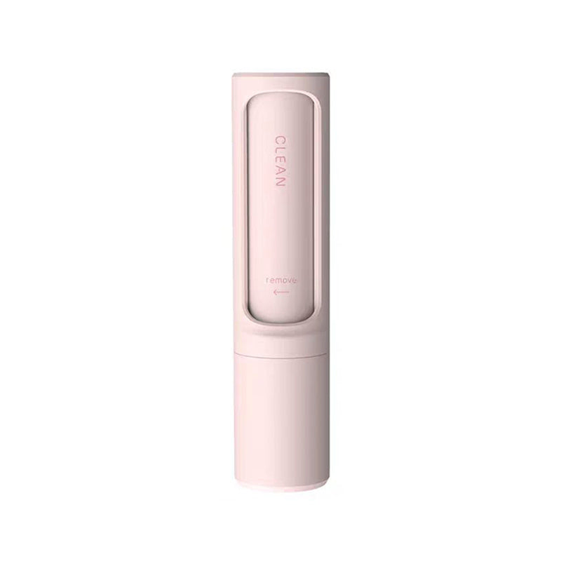 Pink device for pet hair cleaning on a white background