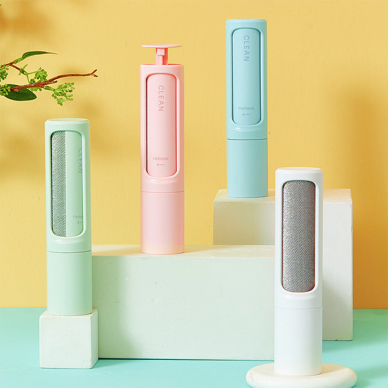 Four cylindrical cleaning devices in pastel colors on a yellow and blue gradient background.