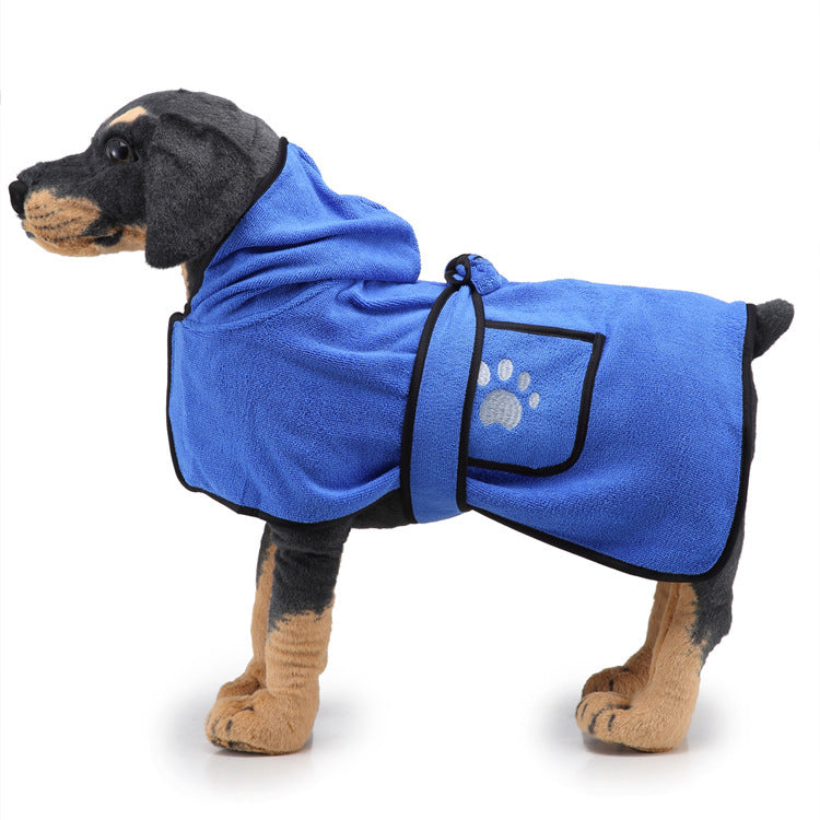 Dog wearing a blue bathrobe with a paw print on a white background