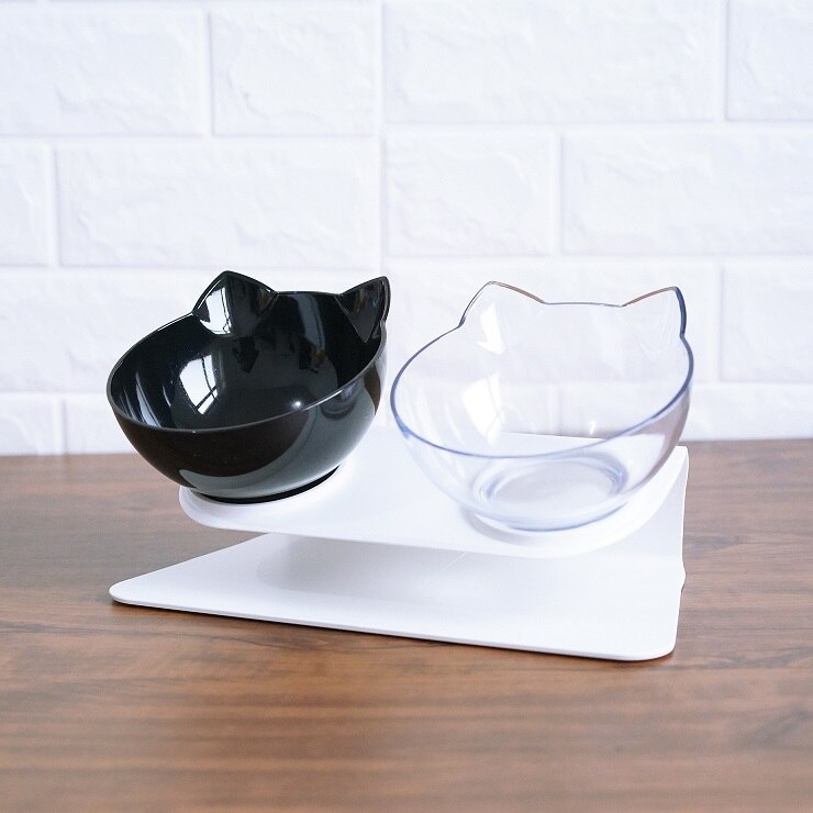 Cat-shaped black and clear bowls on a white stand with a white tiled wall background