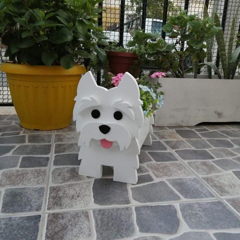 White dog-shaped object on a stone pavement with plants in the background
