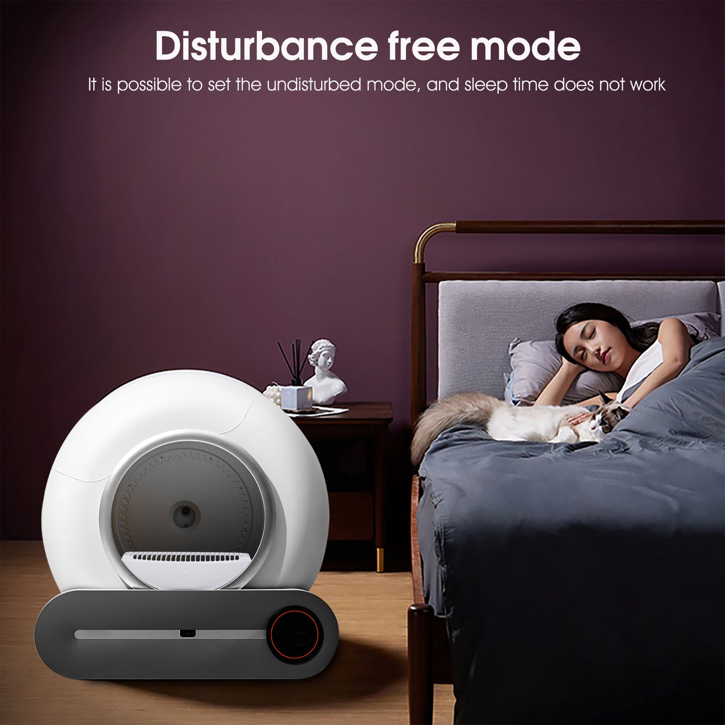 White and gray device on a wooden floor with a person sleeping in bed in the background.
