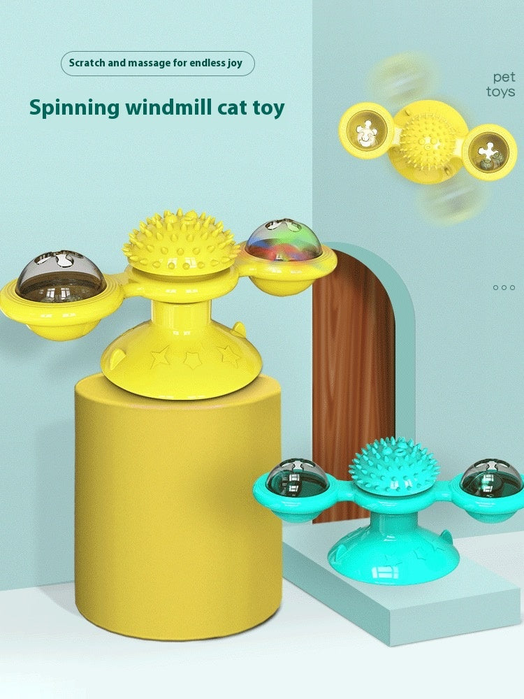 Yellow and turquoise spinning windmill cat toy on a light blue background