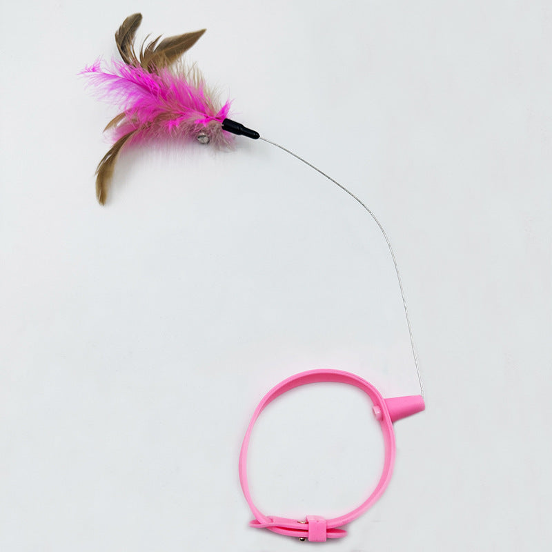 Pink cat toy with feathers on a white background