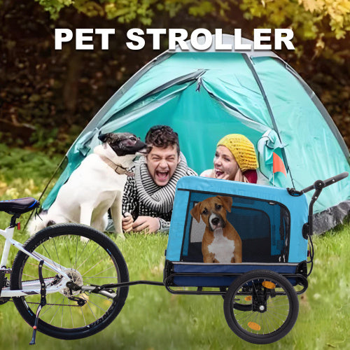 Pet stroller with a bicycle, people, and two dogs in an outdoor setting.