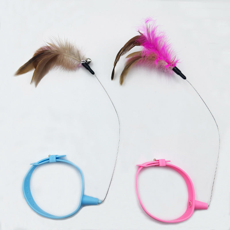 Two cat toys with feathers on strings, one blue and one pink, on a white background.