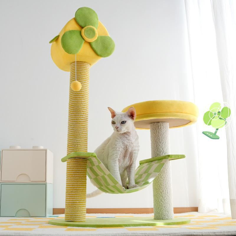Cat sitting on a green and yellow cat tree with a white background
