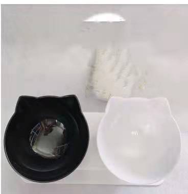 Black and white cat-shaped cups on a white background
