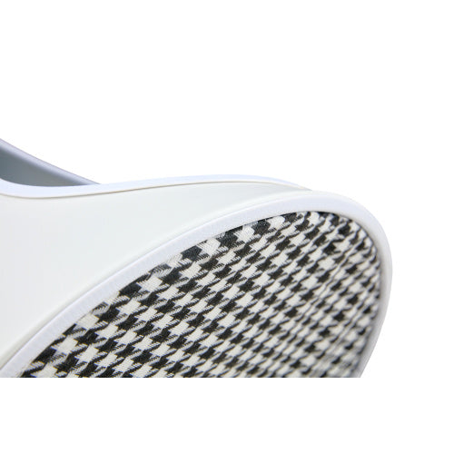 Close-up of a coffee table with a houndstooth pattern on a white background