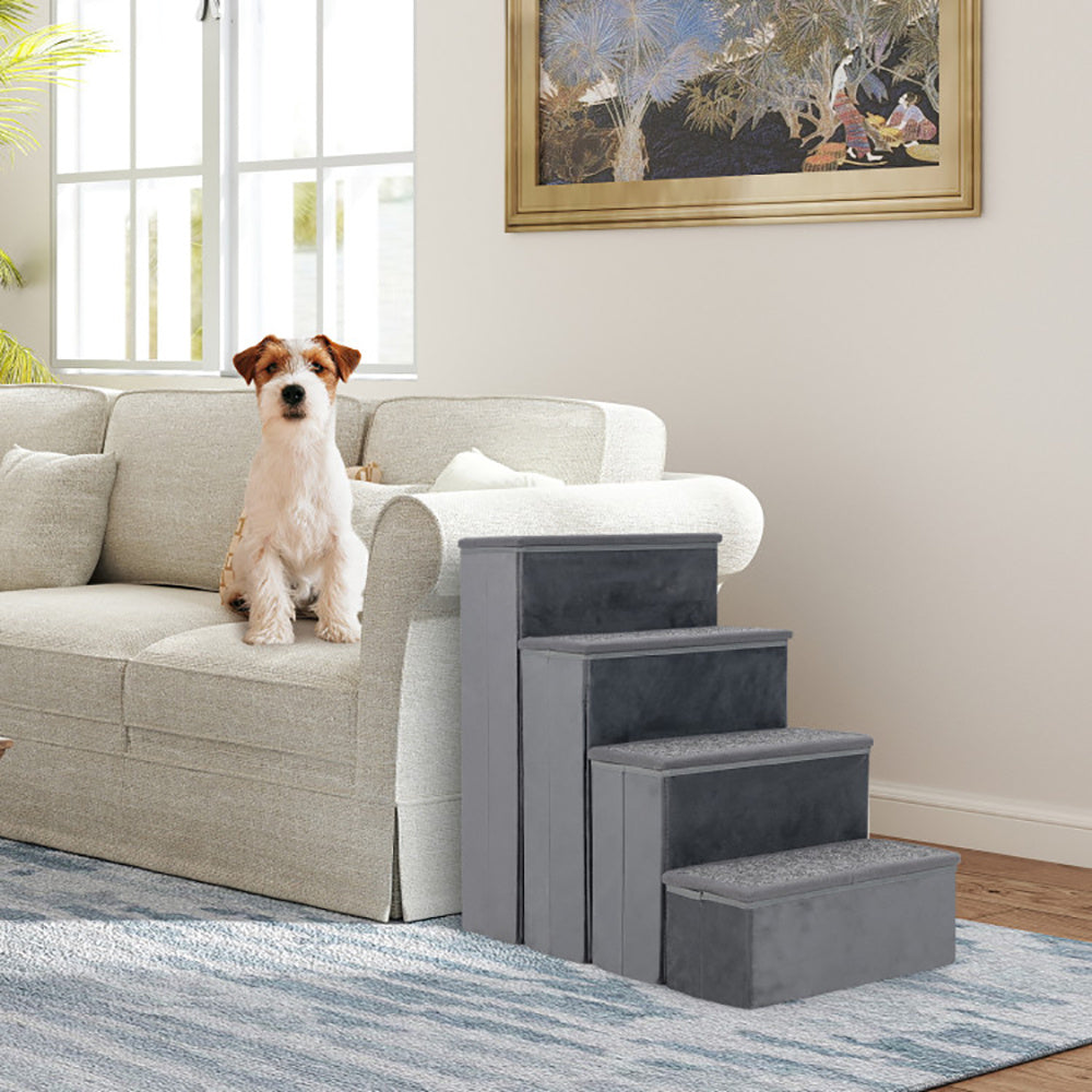 Dog sitting on a couch next to a set of gray pet steps in a living room.