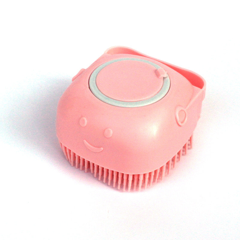 Pink pet grooming brush with a smiley face design on a white background
