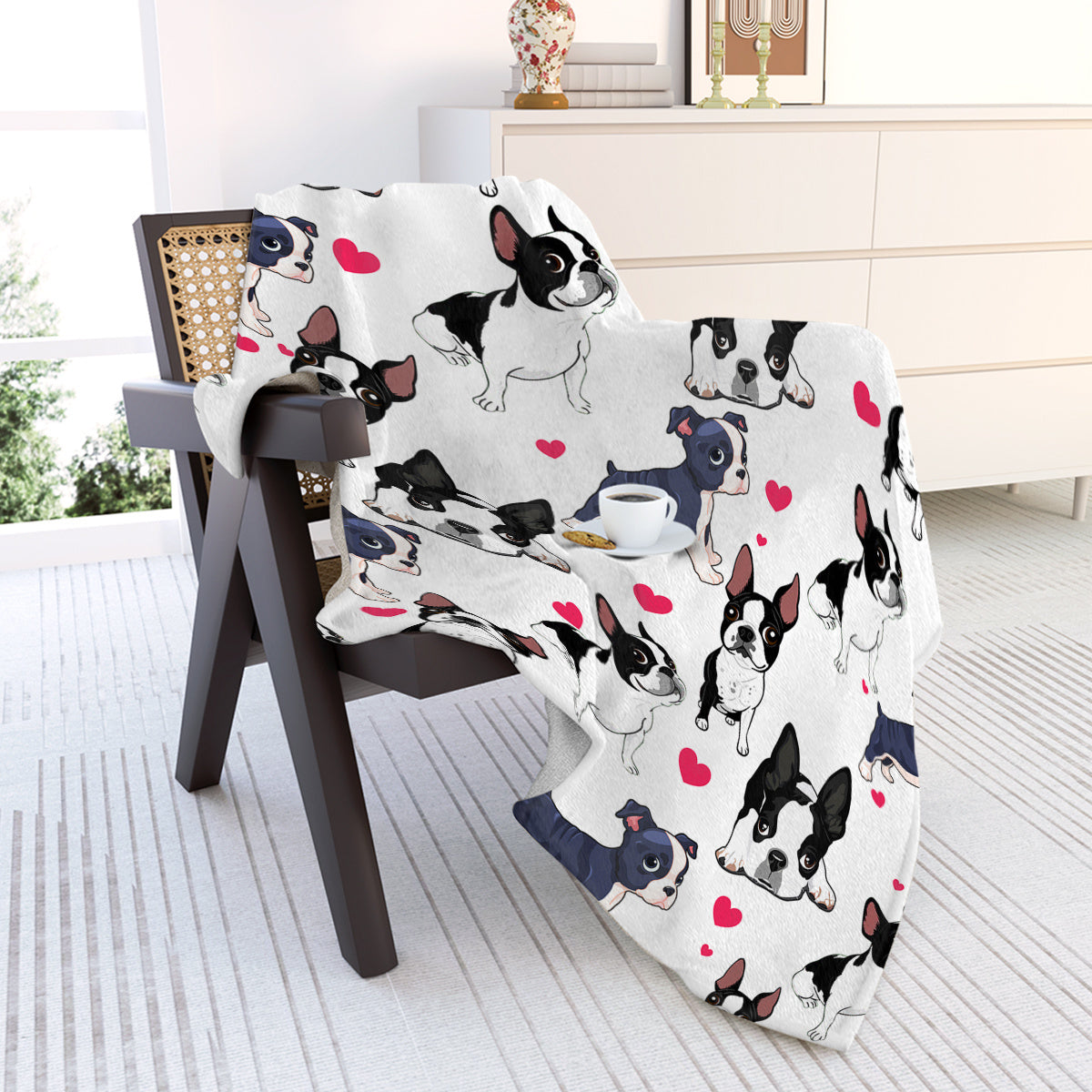 Blanket with dog pattern draped over a chair in a room.