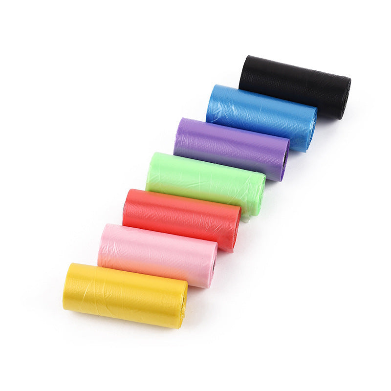 Set of colorful plastic poop bags in various colors on a white background
