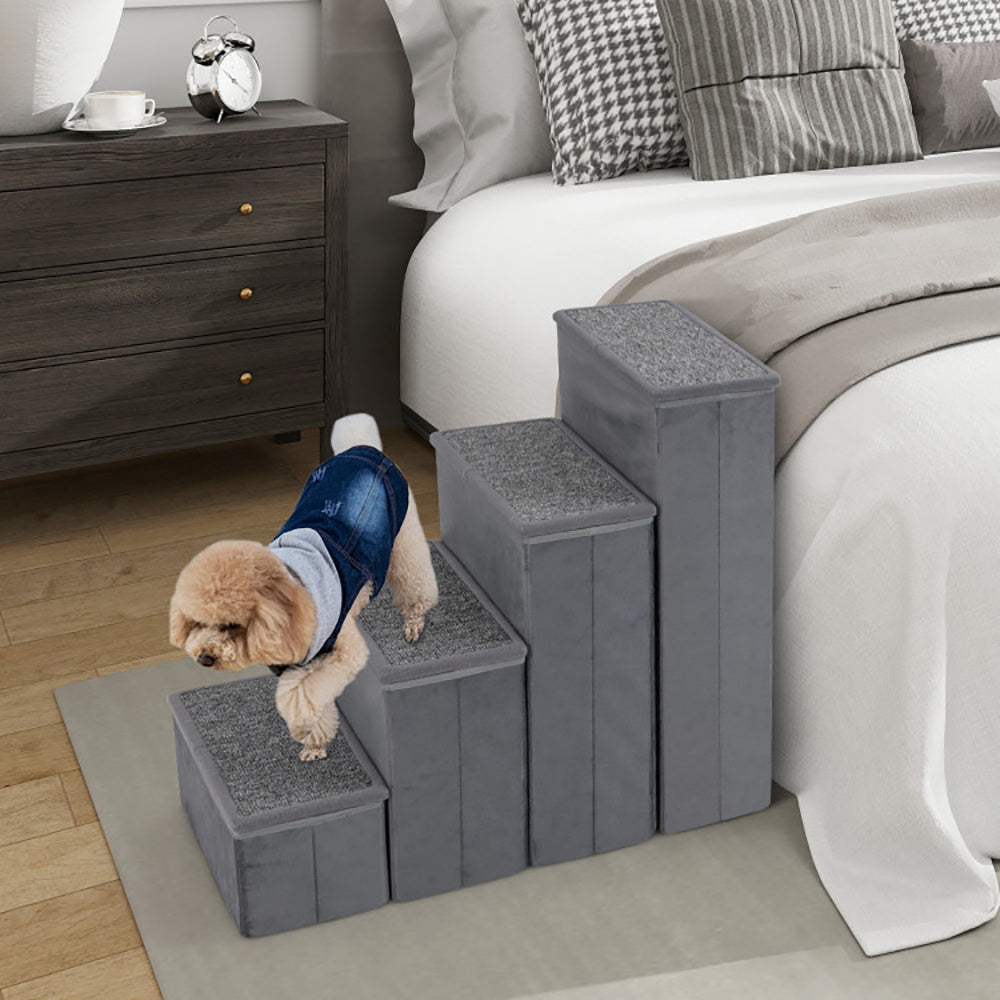 Dog using a gray pet stars next to a bed