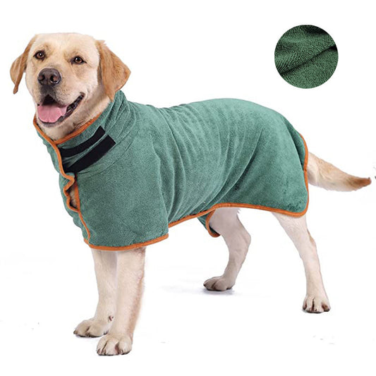 Dog wearing a green towel with orange trim on a white background