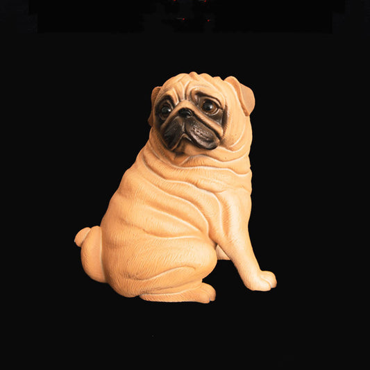 Sculpture of a pug dog on a black background