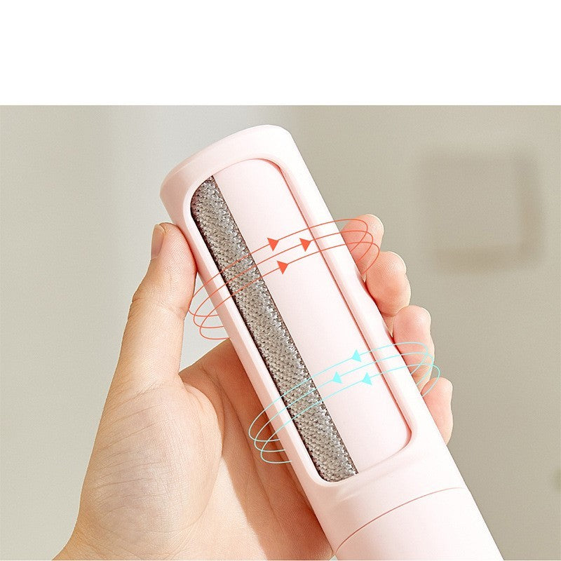 Hand holding a pink pet hair remover with a clear background