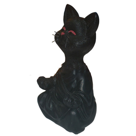 Black cat figurine with red eyes on a white background