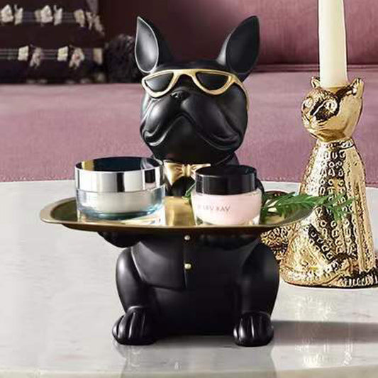 Black dog-shaped table with gold accents and decorative items on a white surface.