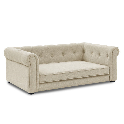 Beige sofa with tufted backrest on a white background