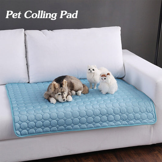 Pet cooling pad on a white couch with three small dogs.