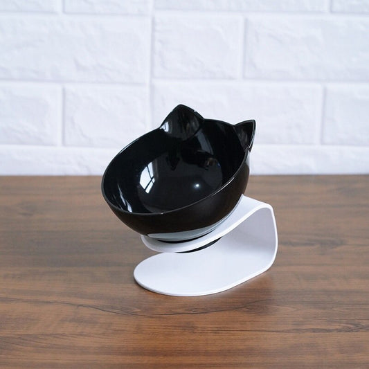 Black cat-shaped bowl on a white stand against a white tiled wall.