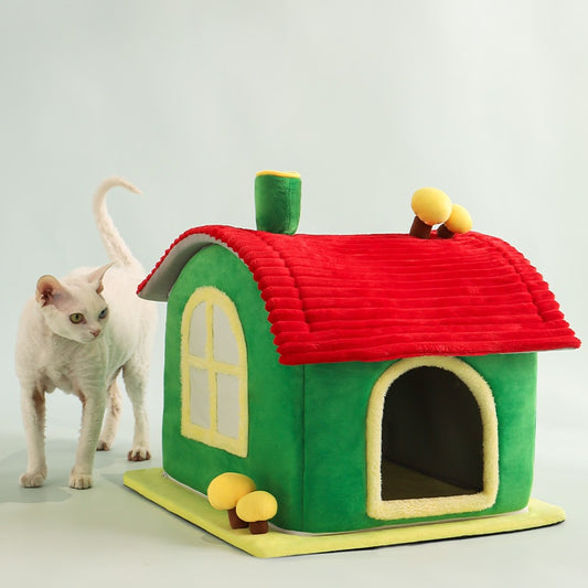 Green and red cat house with a white cat standing next to it on a light gray background