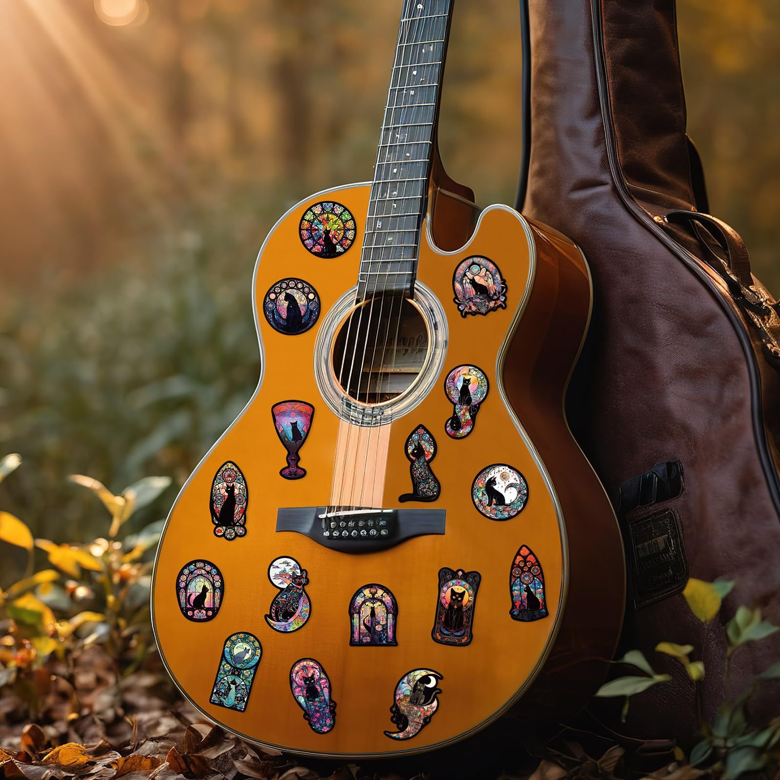 Acoustic guitar with decorative cat stickers outdoors
