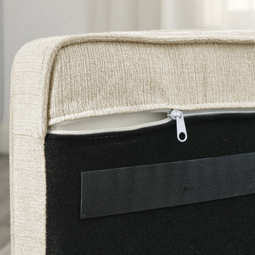 Close-up of a zipper on a beige fabric surface with a neutral background