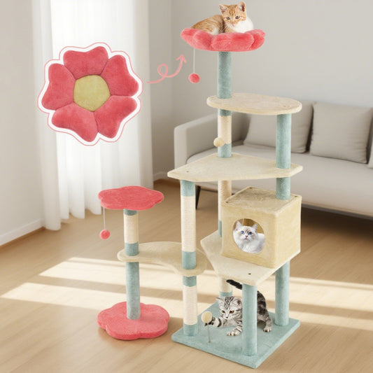 Cat tree with multiple levels and a pink flower toy in a room with a sofa.