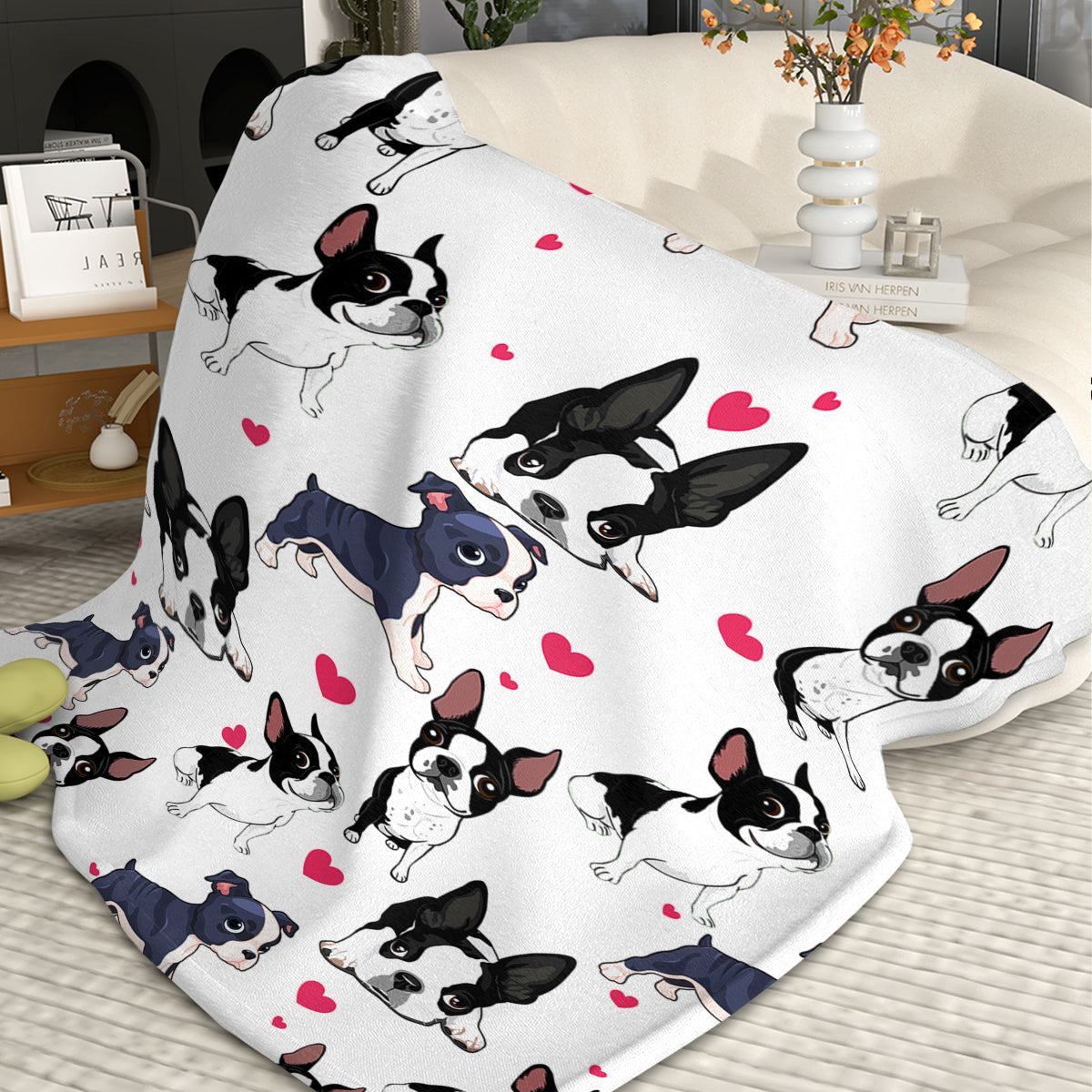 Flannel blanket with cartoon dogs and hearts pattern on a bed.