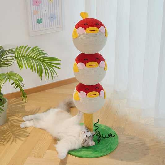 Stacked plush toys on a stand with a cat lying on the floor below