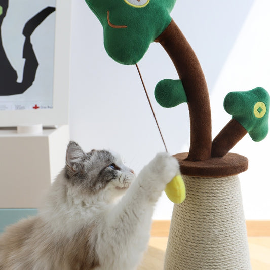 Cat playing with a tree-shaped cat toy indoors