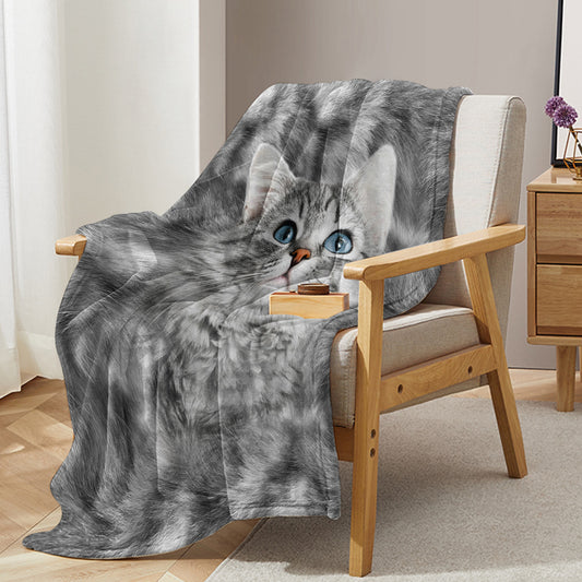 Gray cat blanket draped over a chair with a cat design, in a room setting.