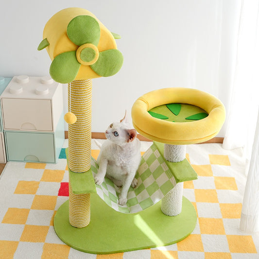 Cat playing on a colorful cat tree with green and yellow accents in a room.